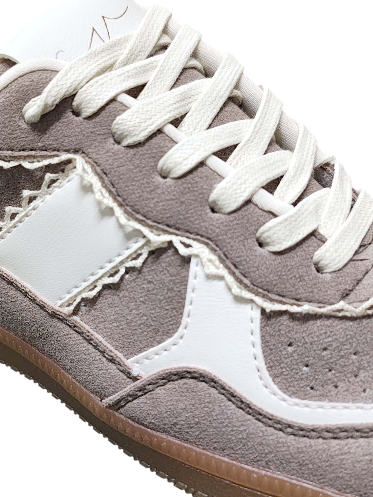 Primer plano del calzado Vento en color beige, enfocando de cerca la transición entre las texturas del material y los acabados de costura urbana.